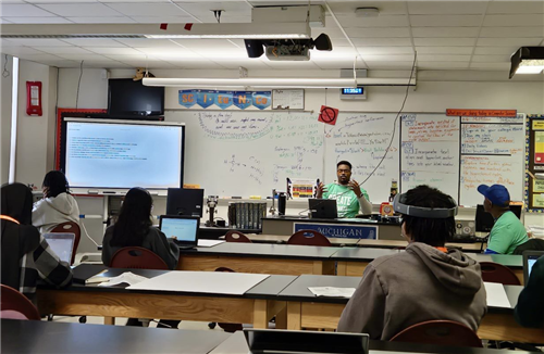 D-Hack presenter and students in Mr. McMillan's CS classroom Western High School